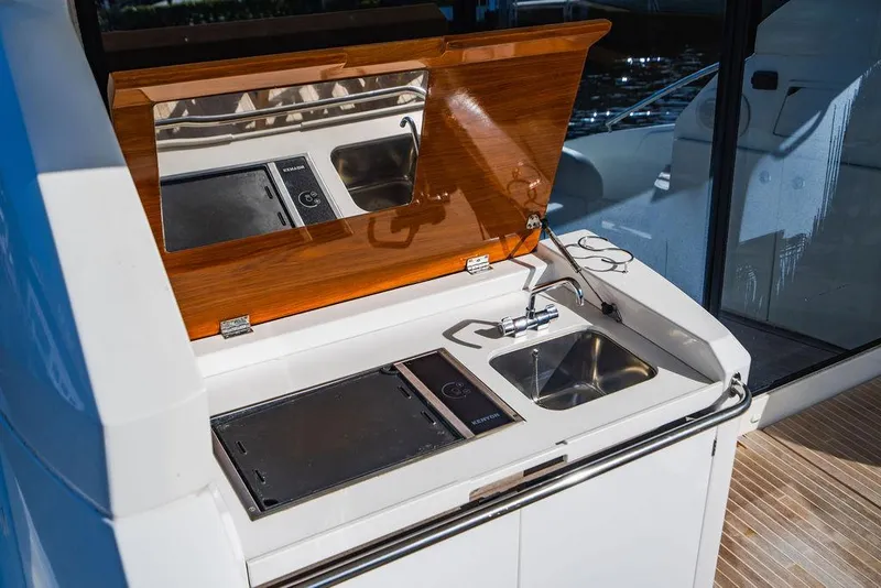 Slide: The Image of Outdoor kitchenette on 2016 Beneteau GRAN TURISMO 49 yacht with sink and grill. - 28