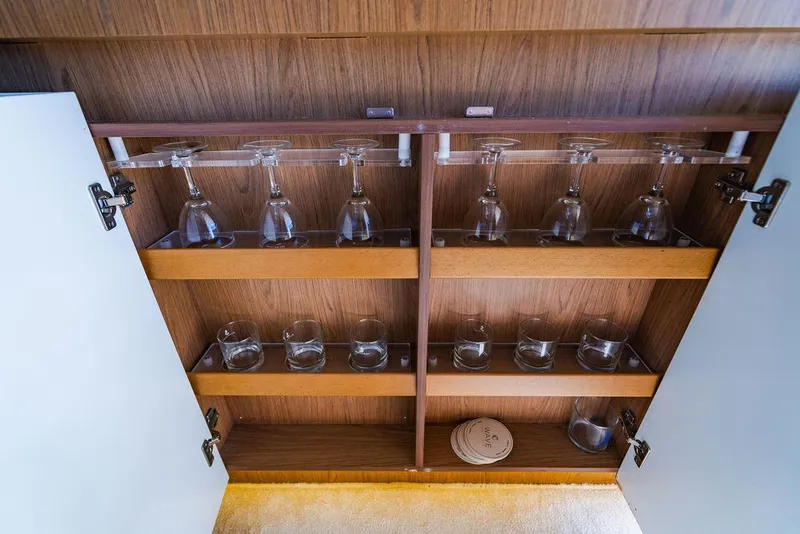 Slide: The Image of Wooden cabinet with glassware storage on a 2016 Beneteau GRAN TURISMO 49 yacht. - 42