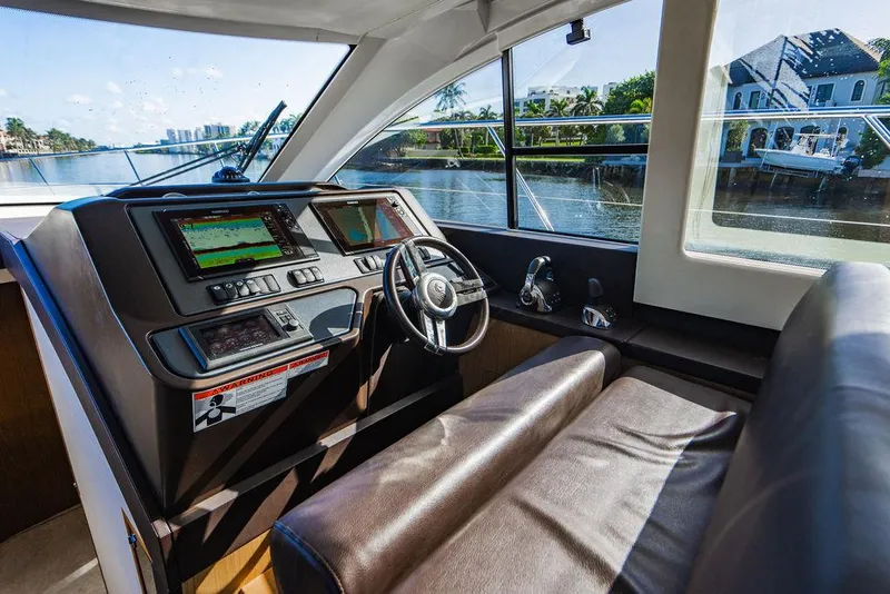 Slide: The Image of Interior helm of 2016 Beneteau Gran Turismo 49 yacht with navigation screens. - 49