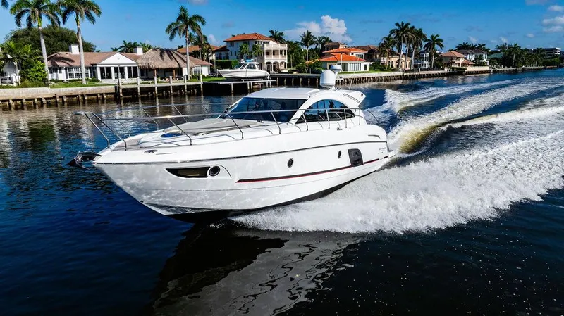 Slide: The Image of 2016 Beneteau GRAN TURISMO 49 yacht cruising on a scenic waterway. - 5