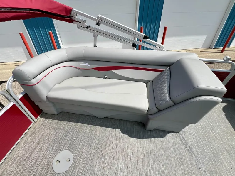 Slide: The Image of 2023 Bennington 20 SVSR boat interior with gray and red seating, under a red canopy. - 10