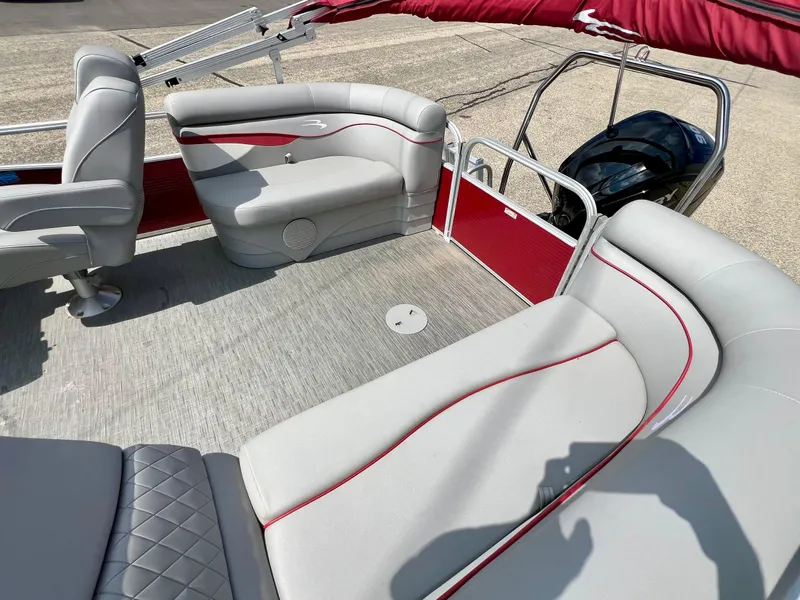 Slide: The Image of 2023 Bennington 20 SVSR pontoon boat interior with gray and red seating, and a visible motor. - 11