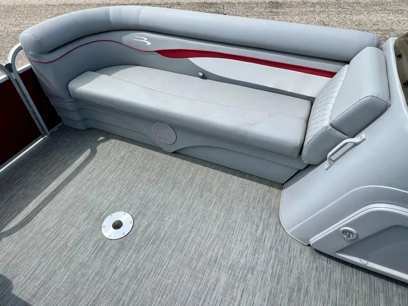 Slide: The Image of 2023 Bennington 20 SVSR pontoon boat interior with gray seating and red accents. - 13