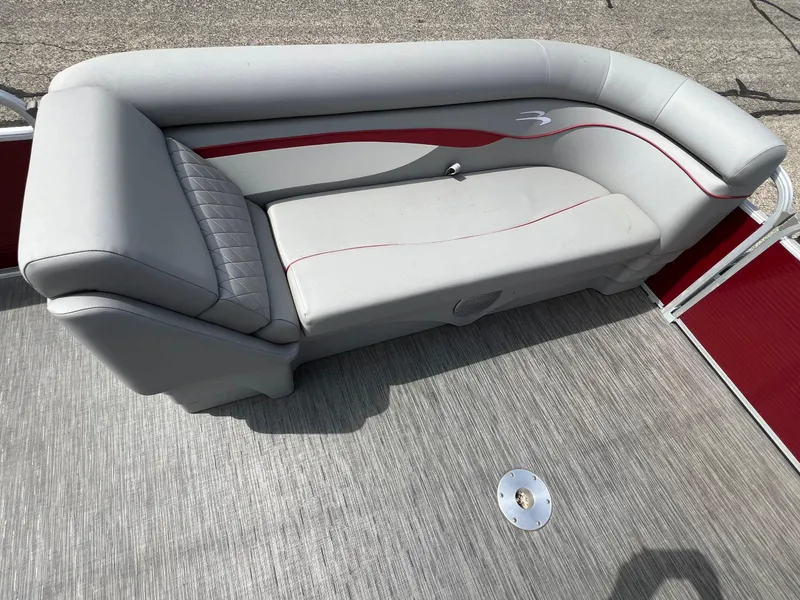 Slide: The Image of 2023 Bennington 20 SVSR pontoon boat with gray seating and red accents. - 17