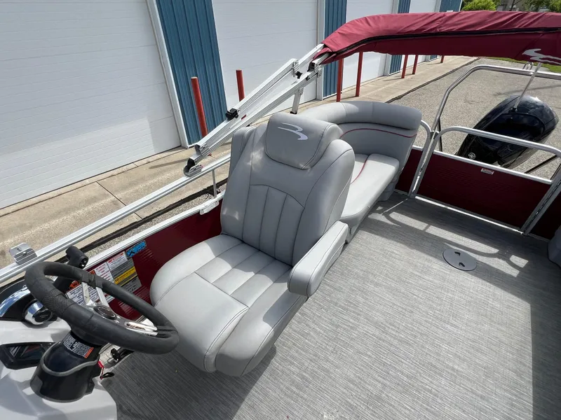 Slide: The Image of 2023 Bennington 20 SVSR pontoon boat with gray seating and maroon canopy. - 19