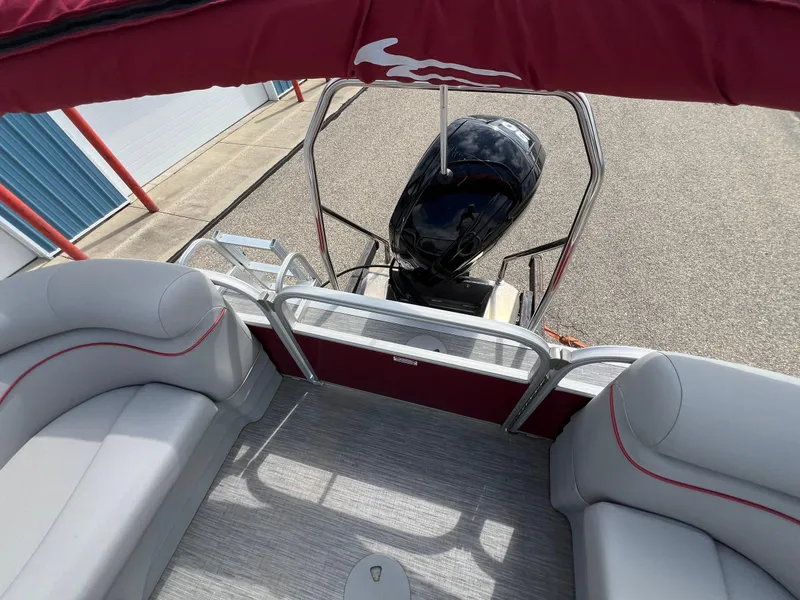 Slide: The Image of 2023 Bennington 20 SVSR pontoon boat interior with seating and outboard motor. - 21