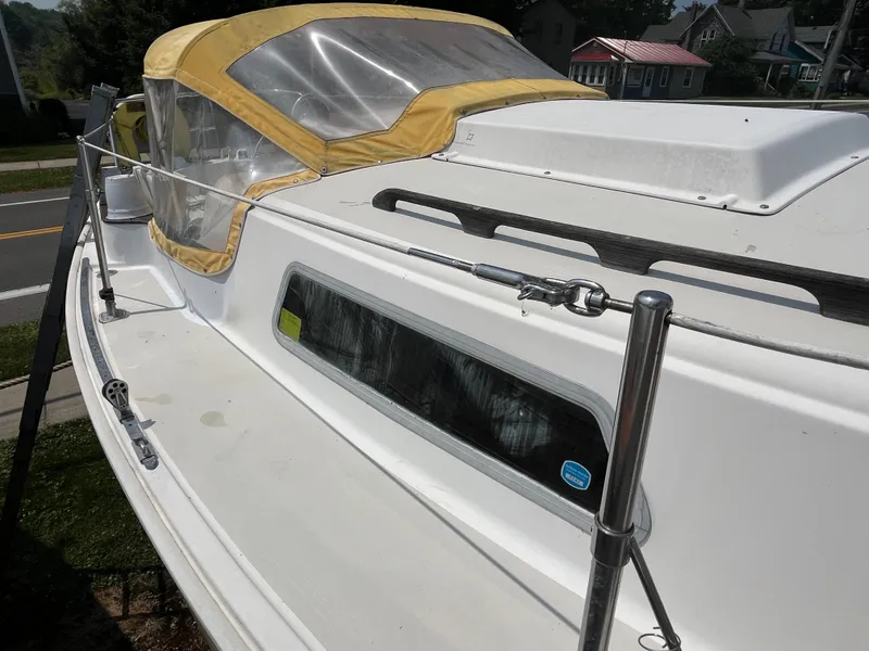 Slide: The Image of 1980 Pearson 30 sailboat with yellow canopy. - 15