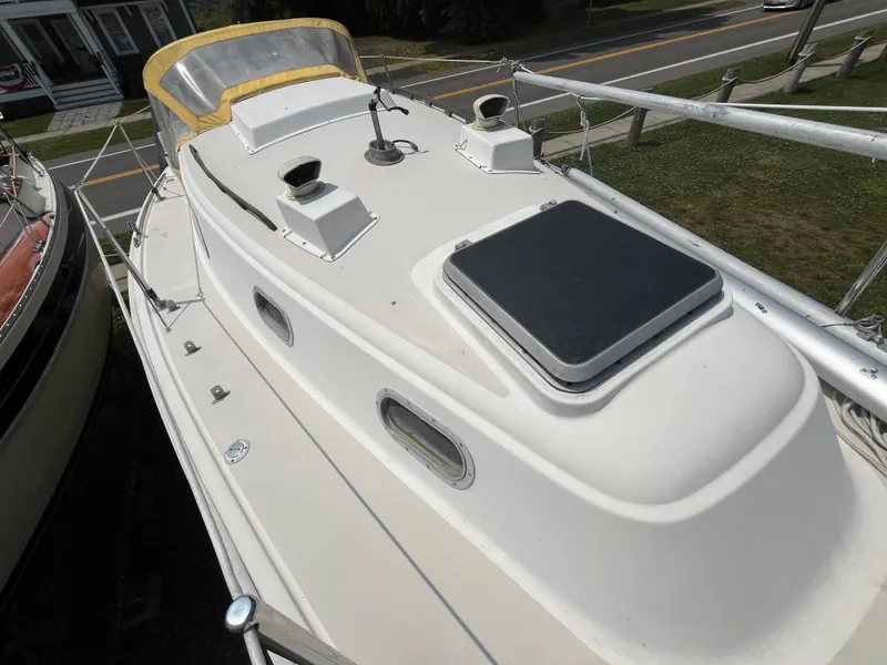 Slide: The Image of 1980 Pearson 30 sailboat deck view with hatches and railing. - 16