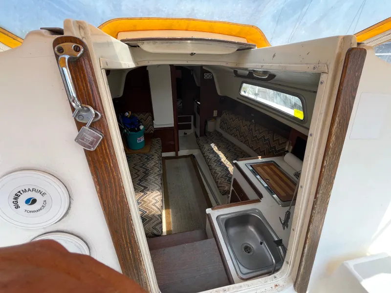 Slide: The Image of Interior of a 1980 Pearson 30 yacht with kitchen and seating area. - 25