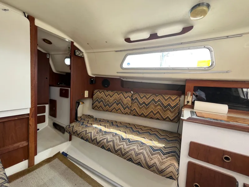 Slide: The Image of Interior of a 1980 Pearson 30 yacht with patterned upholstery. - 30