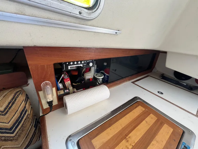 Slide: The Image of Interior of a 1980 Pearson 30 yacht with wood paneling and storage area. - 36