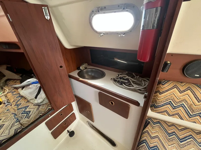 Slide: The Image of Interior of a 1980 Pearson 30 yacht with sink and fire extinguisher. - 41