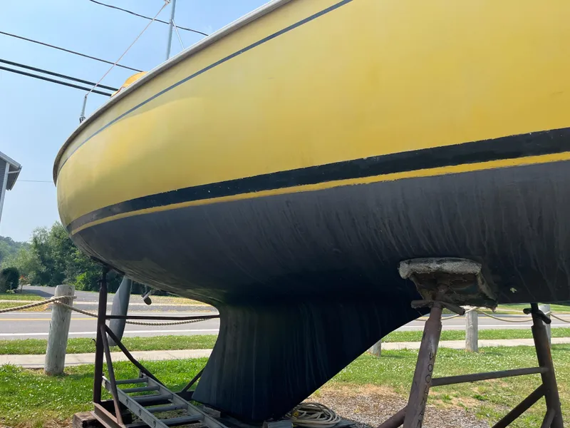 Slide: The Image of 1980 Pearson 30 sailboat on a trailer, yellow hull. - 8