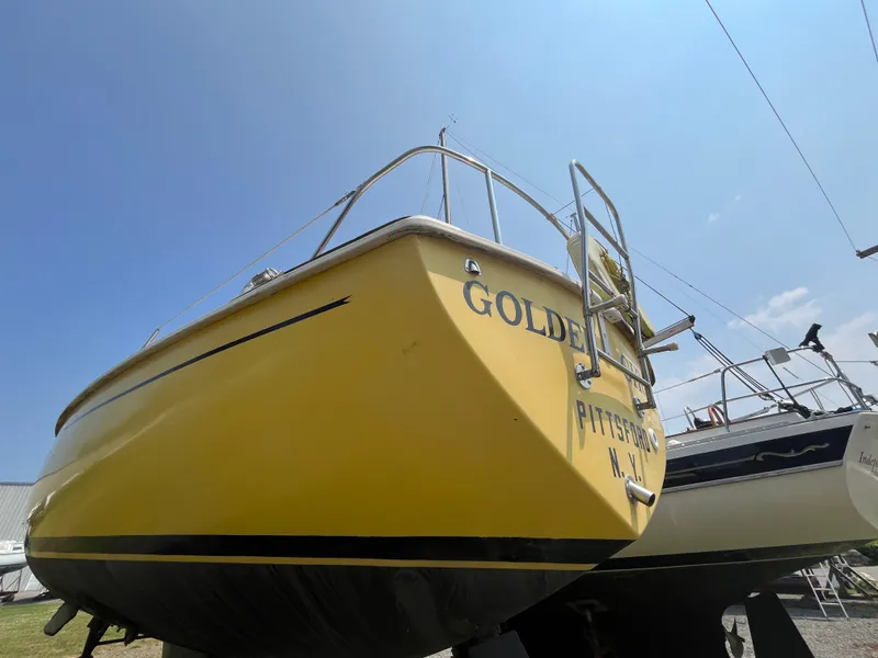 Slide: The Image of Yellow 1980 Pearson 30 sailboat on a dry dock. - 11