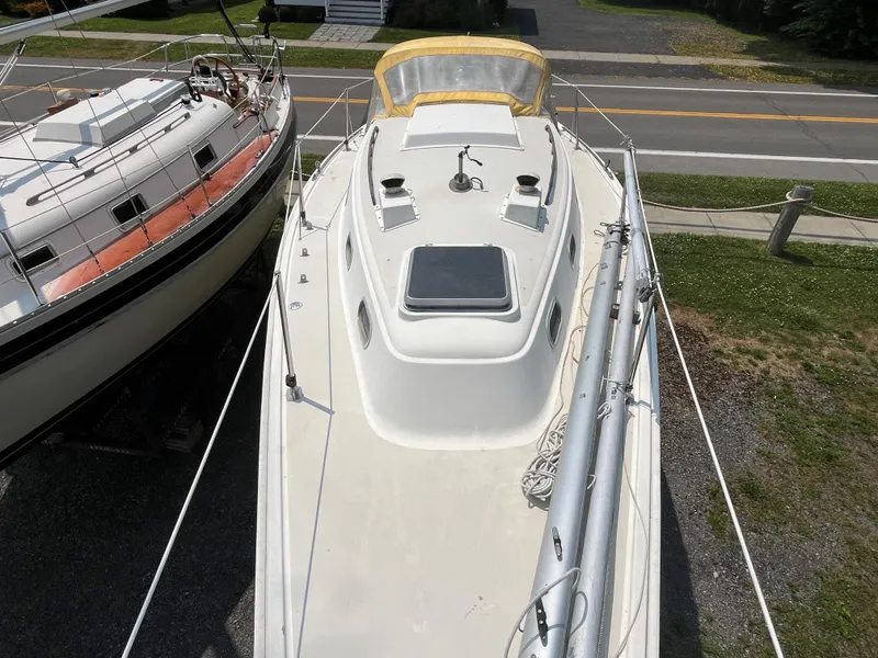 Slide: The Image of 1980 Pearson 30 sailboat parked on a lot. - 19