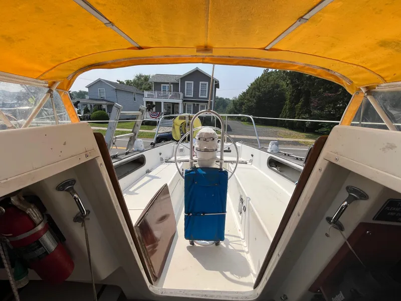 Slide: The Image of Interior view of a 1980 Pearson 30 sailboat with yellow canopy. - 26