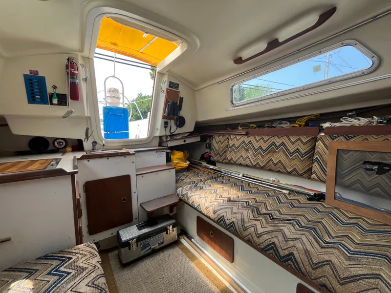Slide: The Image of Interior of a 1980 Pearson 30 sailboat with patterned upholstery. - 33