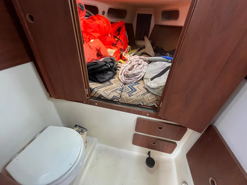Slide: The Image of Interior of a 1980 Pearson 30 yacht with toilet and storage area. - 43