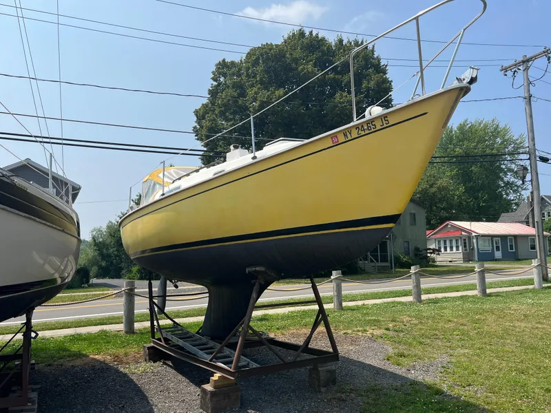 Slide: The Image of Yellow 1980 Pearson 30 sailboat on a stand. - 6
