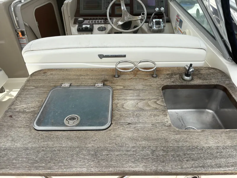 Slide: The Image of 2008 Sea Ray 290 Amberjack boat cockpit with sink and storage compartment. - 12