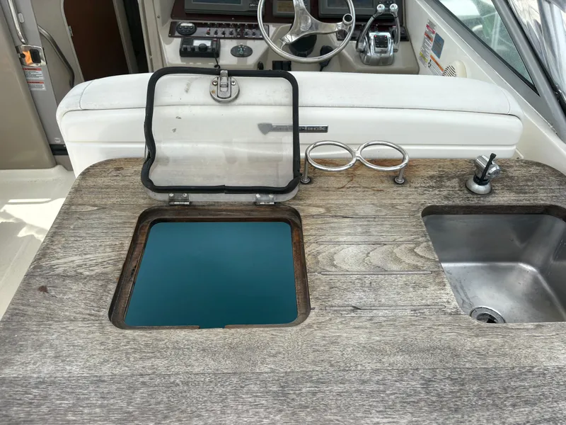 Slide: The Image of 2008 Sea Ray 290 Amberjack boat interior with sink and storage compartment. - 13