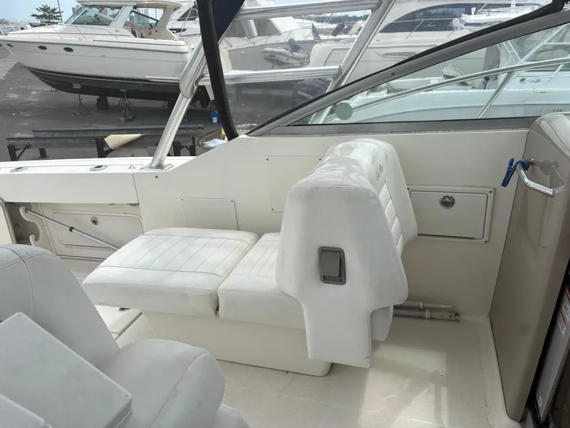 Slide: The Image of 2008 Sea Ray 290 Amberjack interior with white seating and dashboard view. - 14