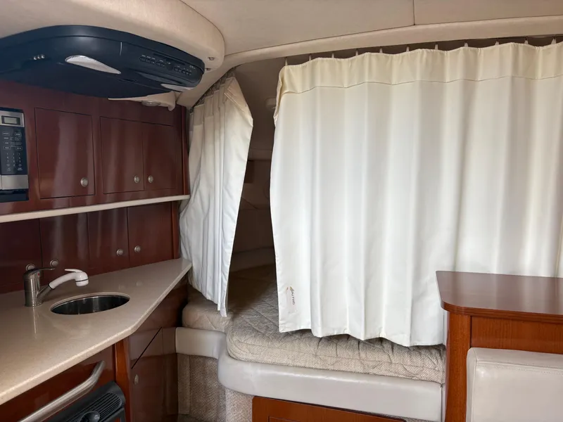 Slide: The Image of 2008 Sea Ray 290 Amberjack cabin interior with kitchenette and sleeping area. - 24