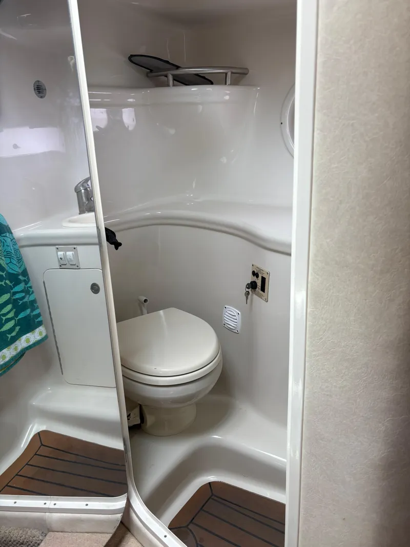 Slide: The Image of 2008 Sea Ray 290 Amberjack boat bathroom with toilet and sink. - 26