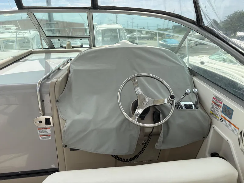 Slide: The Image of Helm of 2008 Sea Ray 290 Amberjack with covered controls and steering wheel. - 9