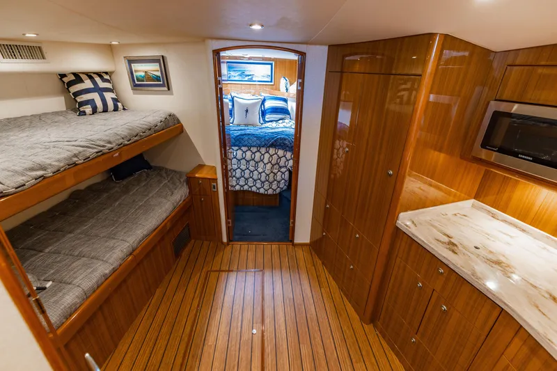 Slide: The Image of Interior of 2020 Viking 46 Billfish yacht with wood finish and cozy sleeping area. - 11