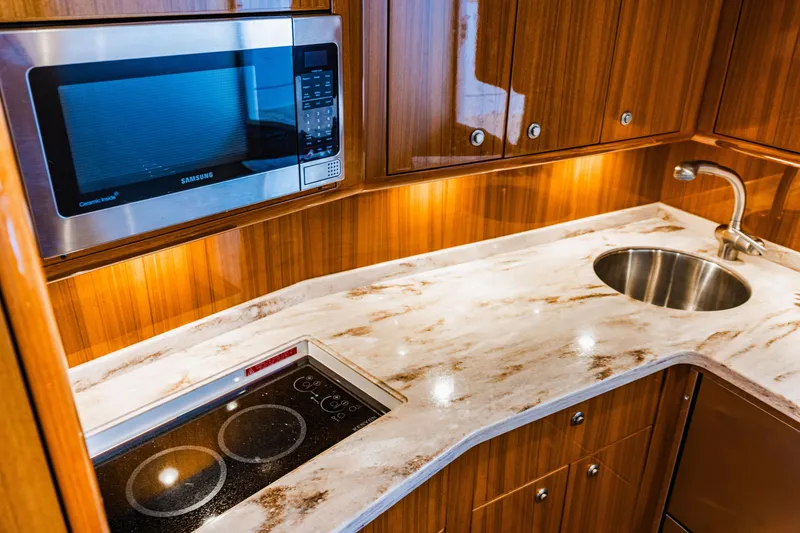 Slide: The Image of Luxurious kitchen in 2020 Viking 46 Billfish yacht with modern appliances and elegant wood cabinetry. - 13