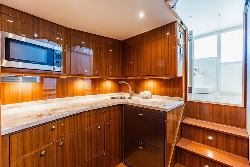 Slide: The Image of Luxurious 2020 Viking 46 Billfish yacht interior kitchen with wood cabinetry and modern appliances. - 14