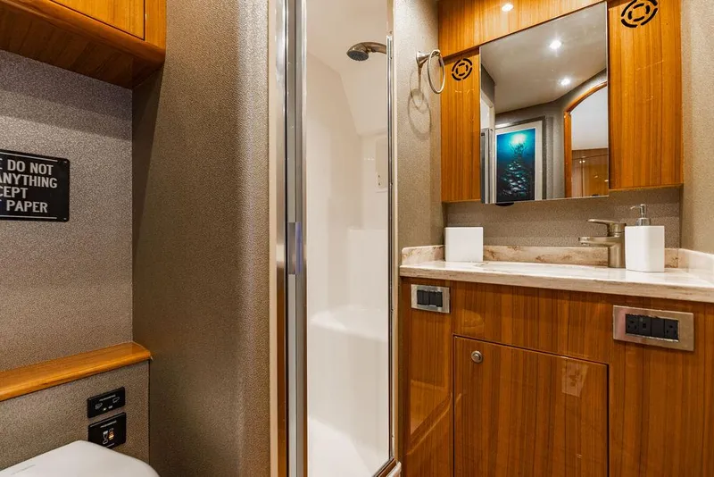 Slide: The Image of Luxurious bathroom in 2020 Viking 46 Billfish yacht with wood cabinetry and modern fixtures. - 17