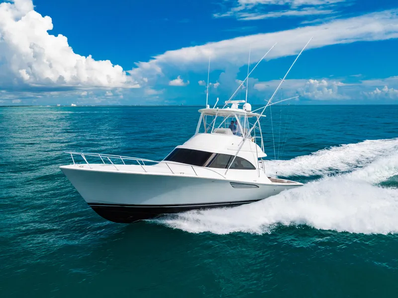 Slide: The Image of 2020 Viking 46 Billfish yacht cruising on open ocean under clear blue sky. - 2