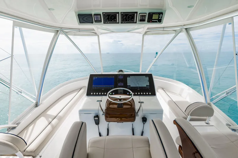 Slide: The Image of Interior view of 2020 Viking 46 Billfish yacht helm with ocean backdrop. - 20