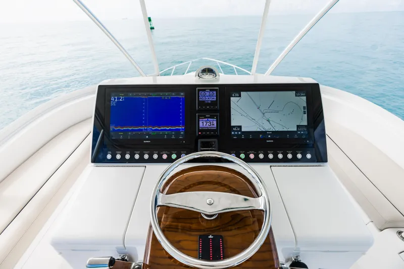 Slide: The Image of Viking 46 Billfish 2020 helm with dual navigation screens and wooden steering wheel. - 21