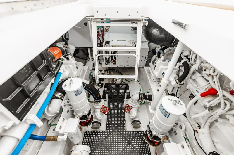 Slide: The Image of Engine room of 2020 Viking 46 Billfish, showcasing clean, organized mechanical layout. - 26