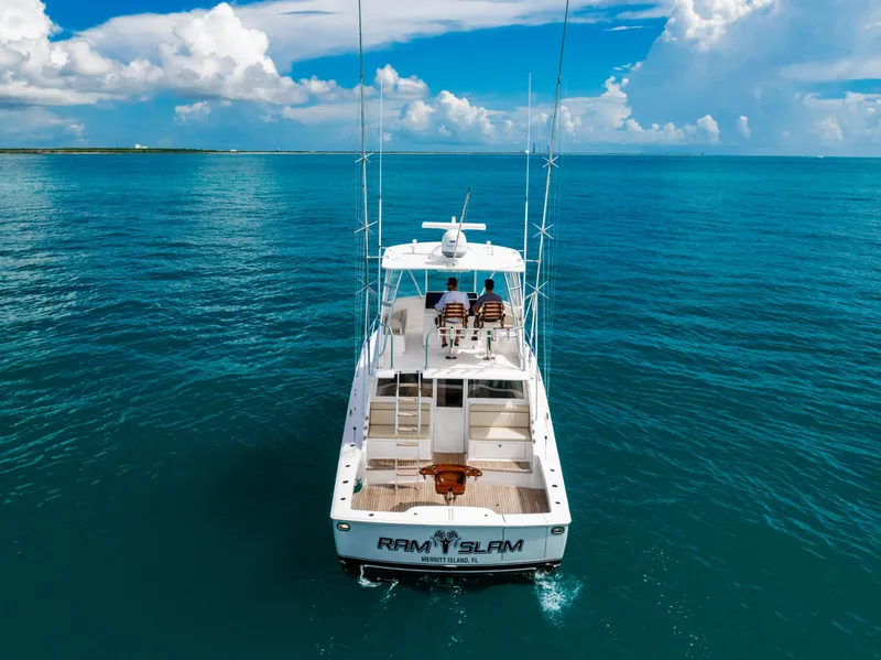 Slide: The Image of 2020 Viking 46 Billfish yacht cruising on open blue ocean under clear skies. - 4