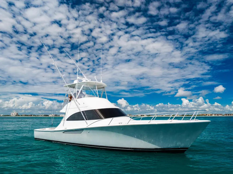 Slide: The Image of 2020 Viking 46 Billfish yacht on open water under a vibrant sky. - 5