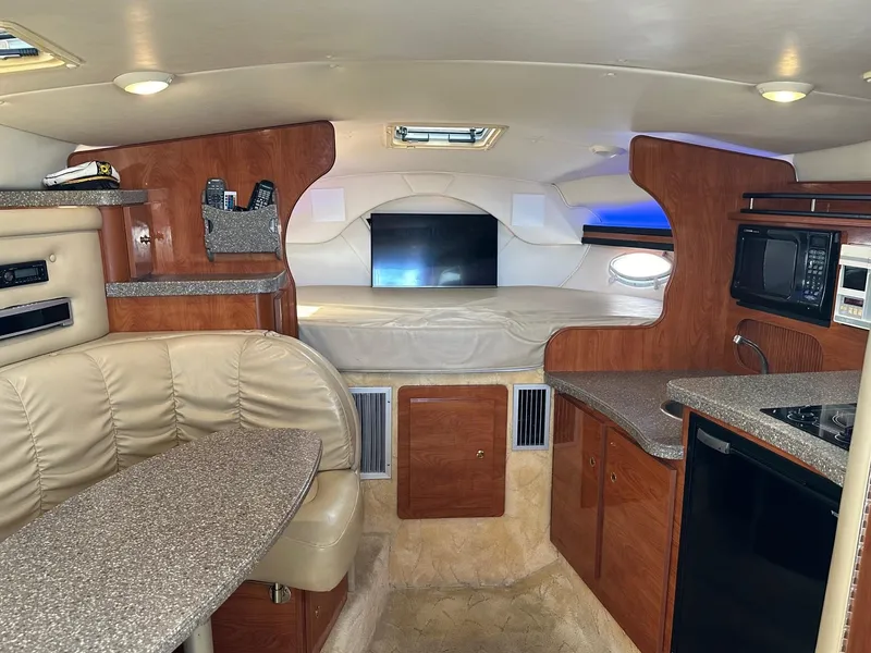 Slide: The Image of Interior of 2004 Rinker Fiesta Vee 312 boat with kitchenette and seating area. - 17