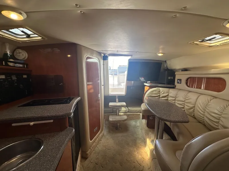 Slide: The Image of Interior of 2004 Rinker Fiesta Vee 312 yacht with kitchen and seating area. - 19