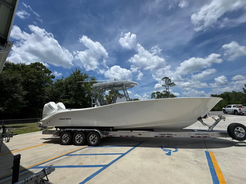 Slide: The Image of 2026 Cape Horn 34 XS boat on trailer under a partly cloudy sky. - 11
