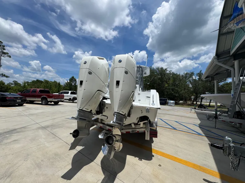 Slide: The Image of 2026 Cape Horn 34 XS boat with dual outboard engines in a sunny parking lot. - 15