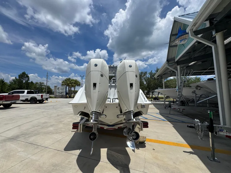 Slide: The Image of 2026 Cape Horn 34 XS boat with dual outboard motors in a sunny marina. - 16