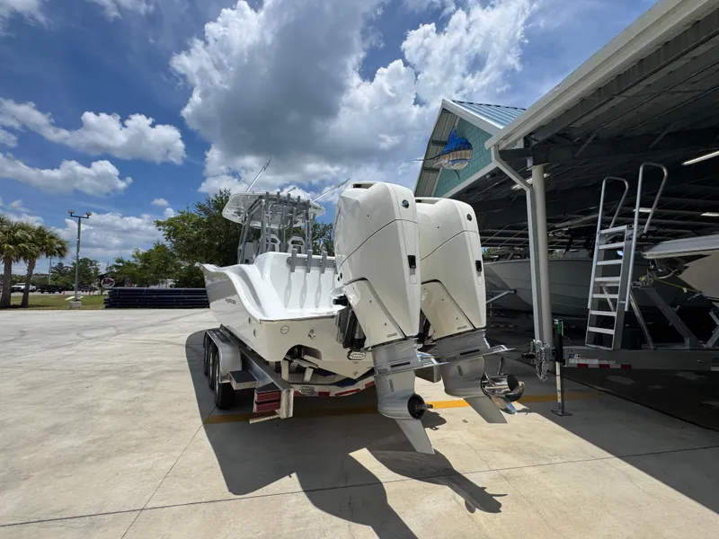 Slide: The Image of 2026 Cape Horn 34 XS boat with dual outboard engines on a trailer, under a sunny sky. - 17