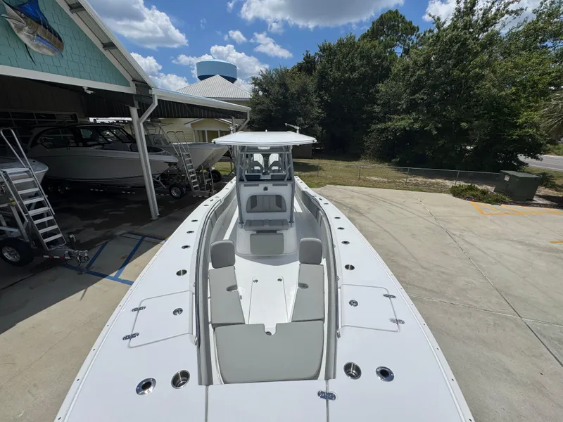 Slide: The Image of 2026 Cape Horn 34 XS boat docked, showcasing spacious deck and seating under a clear sky. - 25