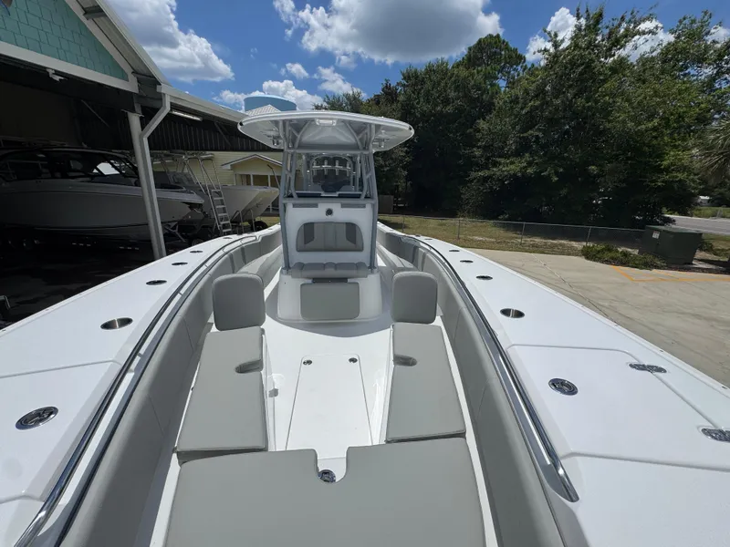 Slide: The Image of 2026 Cape Horn 34 XS boat with spacious deck and seating, under a partly cloudy sky. - 26