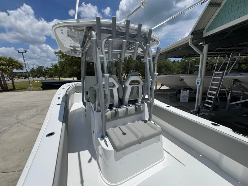 Slide: The Image of 2026 Cape Horn 34 XS boat with seating and rod holders, docked under a cloudy sky. - 36