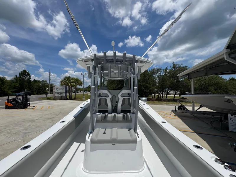 Slide: The Image of 2026 Cape Horn 34 XS boat with T-top, docked under a partly cloudy sky. - 37