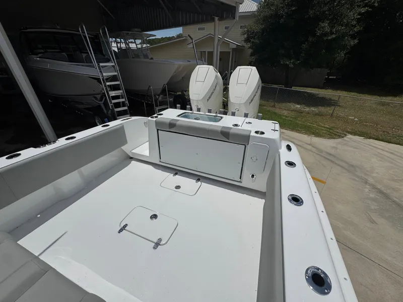 Slide: The Image of 2026 Cape Horn 34 XS boat with dual Mercury engines, docked in a marina. - 38